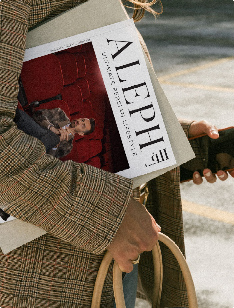 Woman in a plaid coat carrying ALEPH Magazine